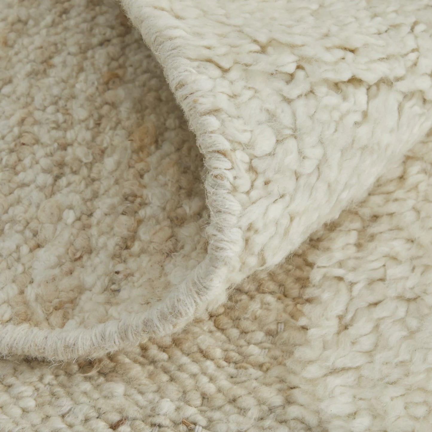 Close-up of ivory wool rug texture