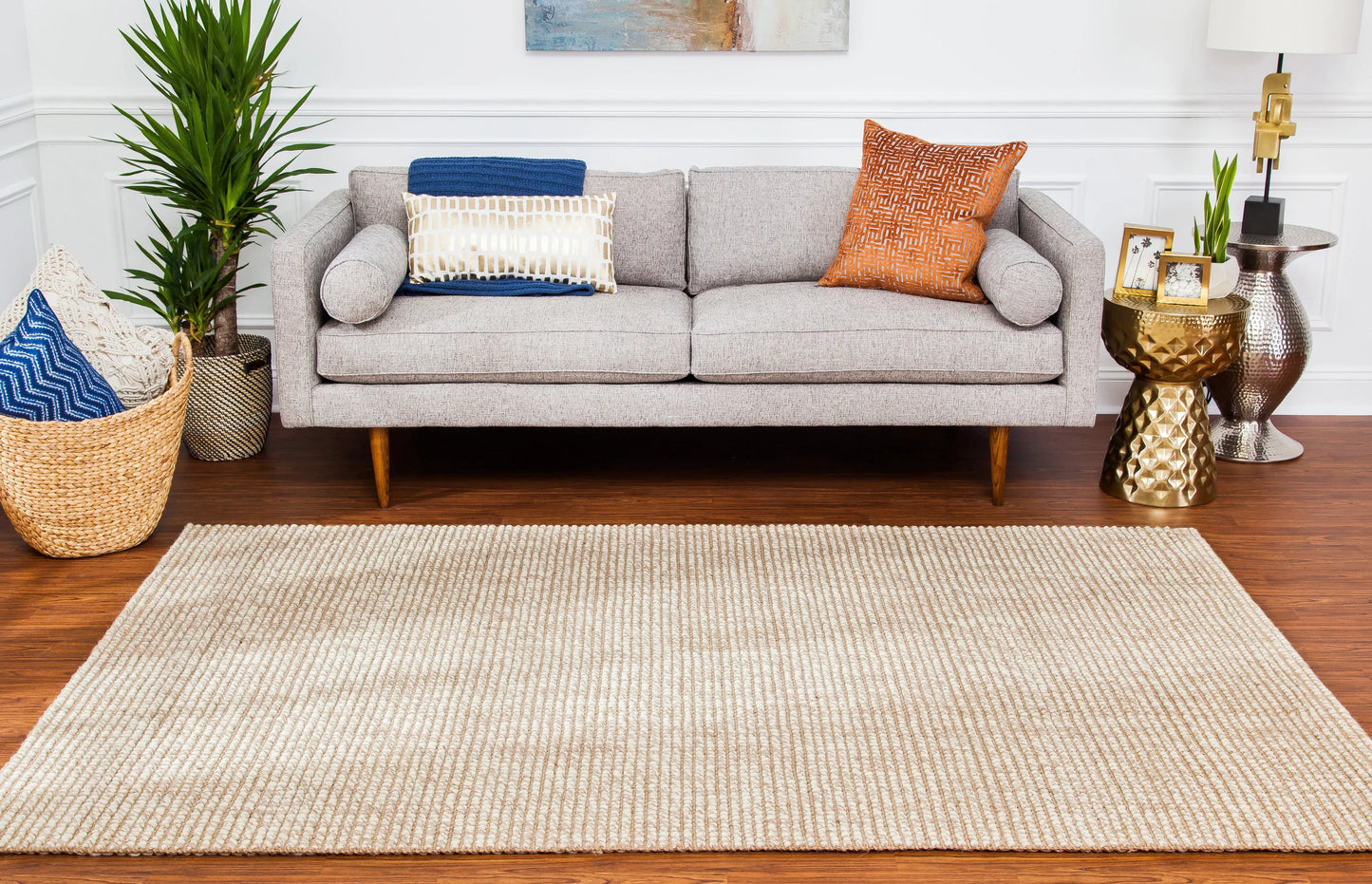 gray couch, natural beige and ivory woven rug and boho decor