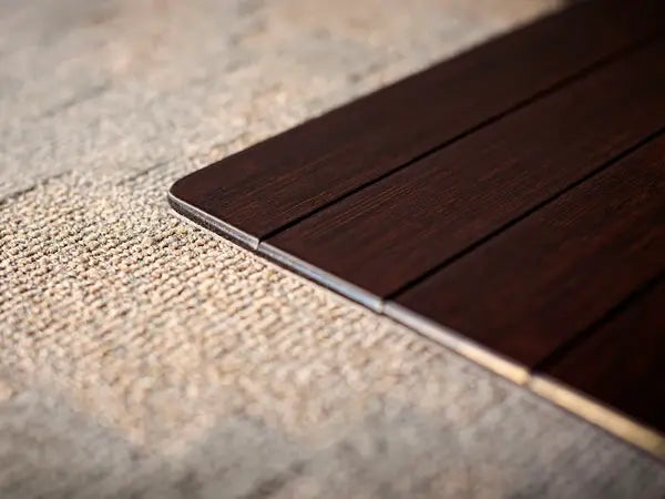 side view of bamboo chair mat corner of carpet