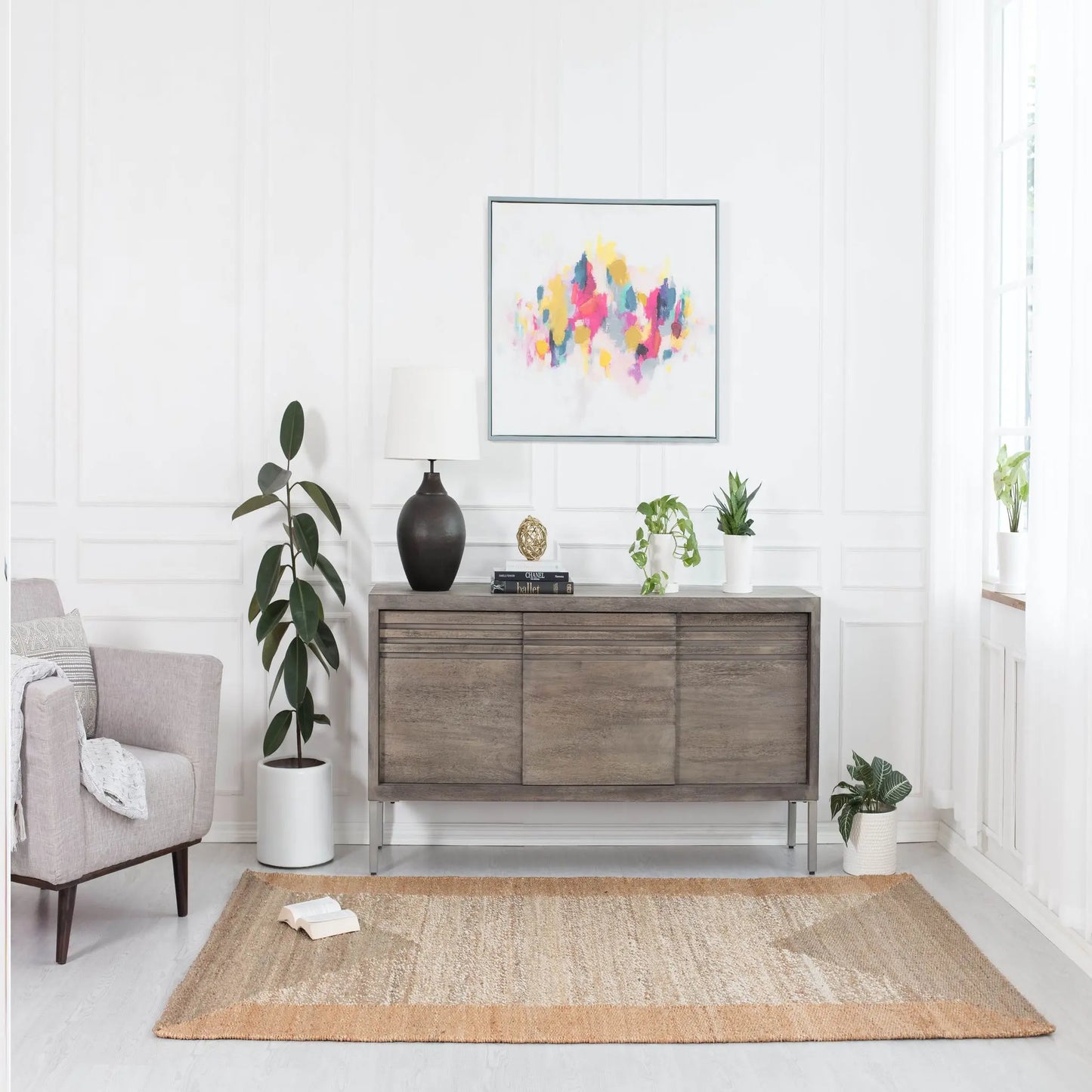small tan and beige geometric run in front of wooden credenza and gray chair