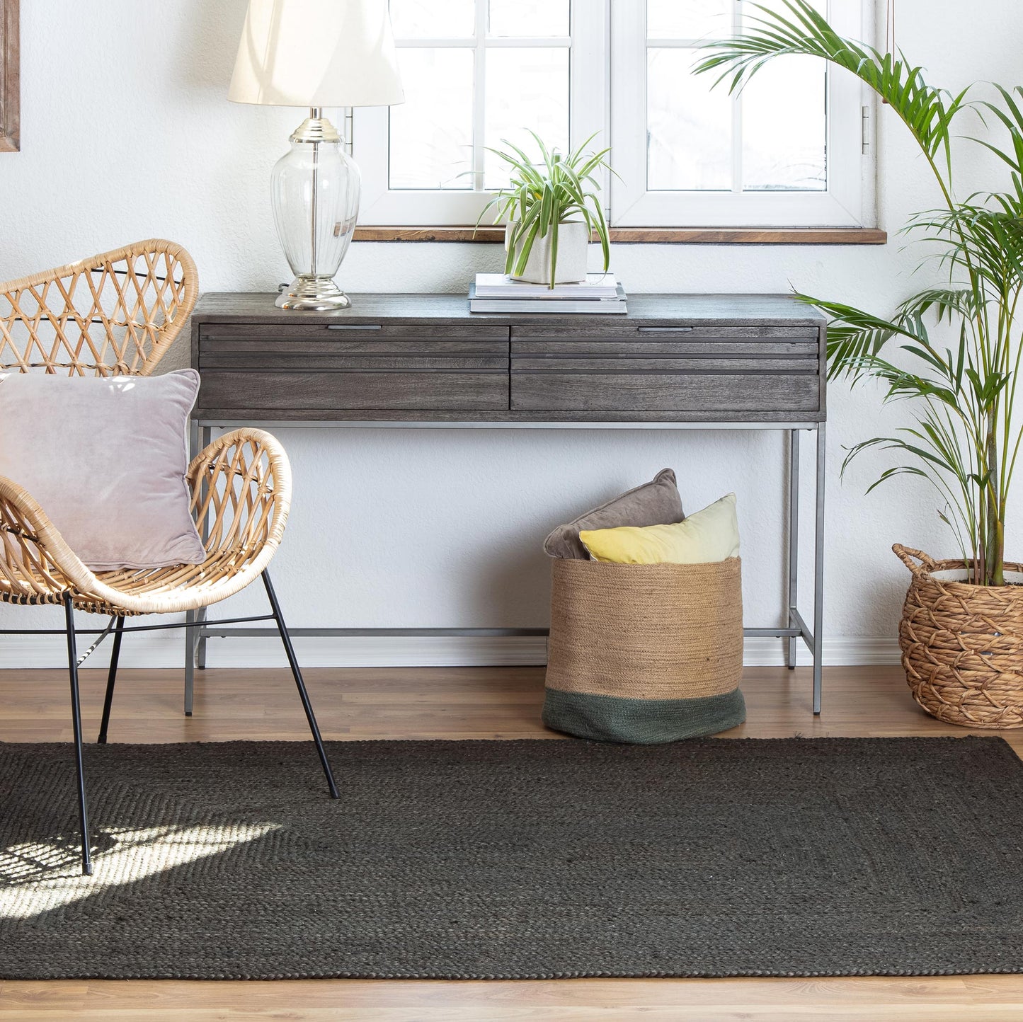 Kerala Gray Jute Rug with wicker chair and credenza