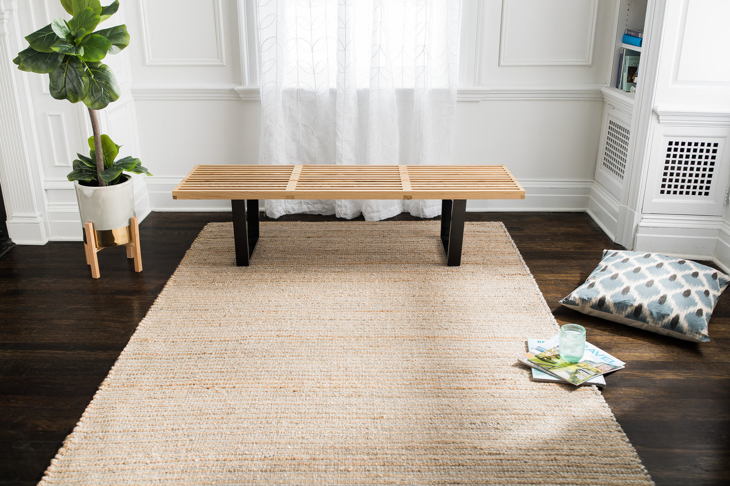 Madeline Handloom Woven Jute & Wool Rug under wooden bench in front of window