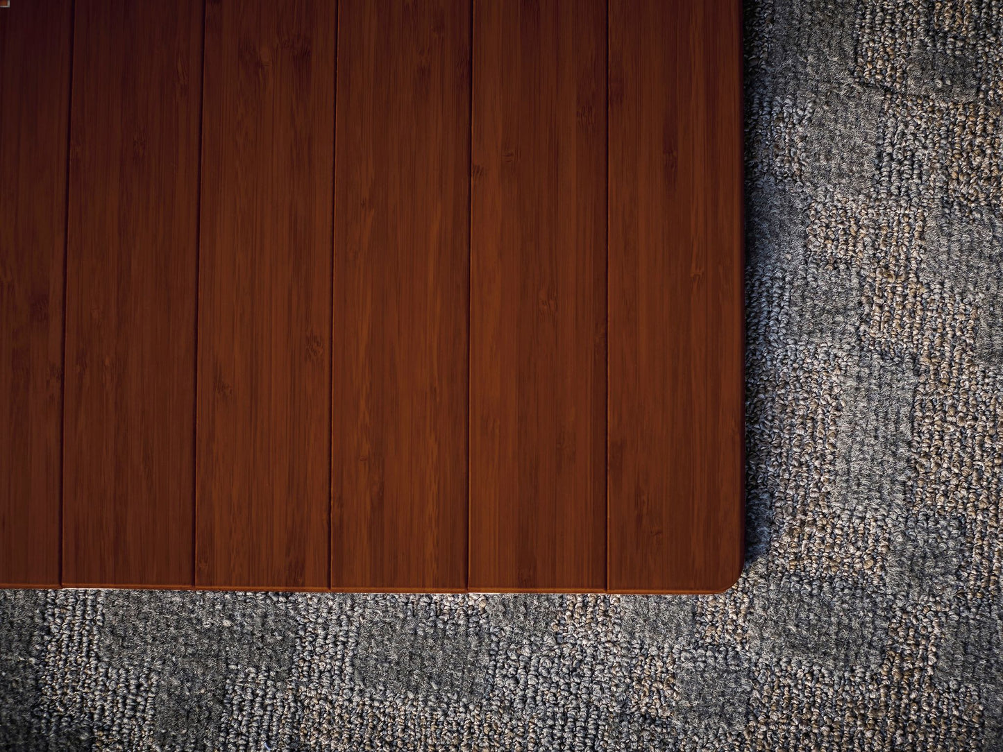 rounded corner of walnut bamboo mat on carpet