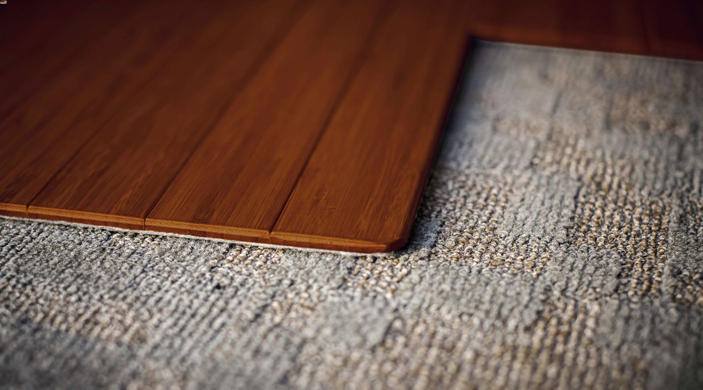 corner detail of bamboo chair mat on patterned rug