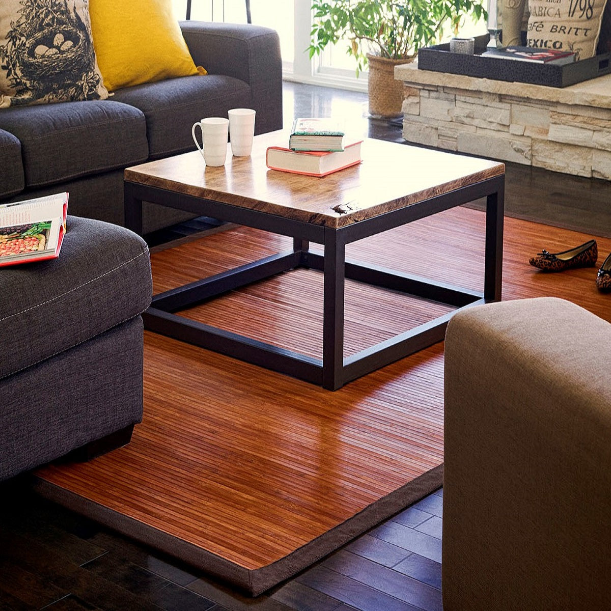 brown bamboo rug beneath a square occasional table