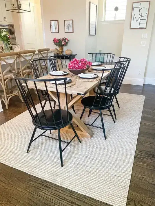 dining room with light table, dark chairs and ivory jute rug