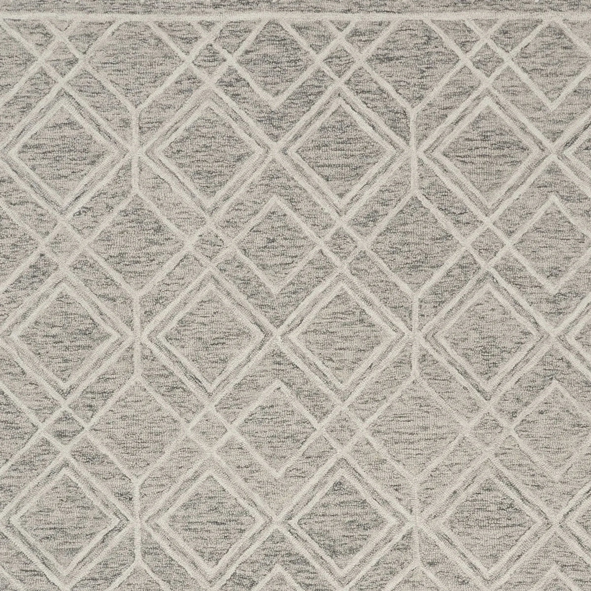 texture close up of gray and ivory wool rug with diamond pattern
