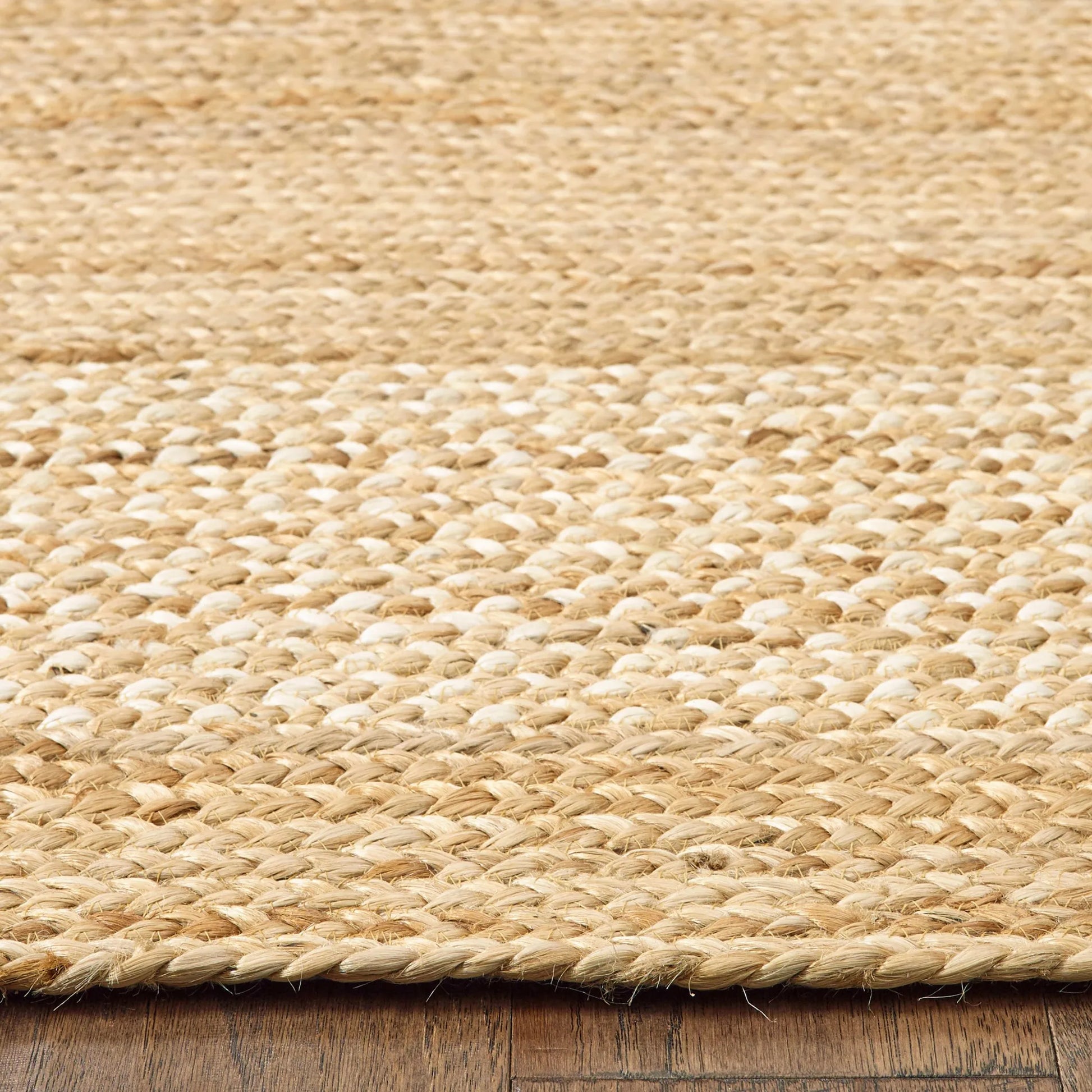 edge close-up of classic tan bordered jute rug