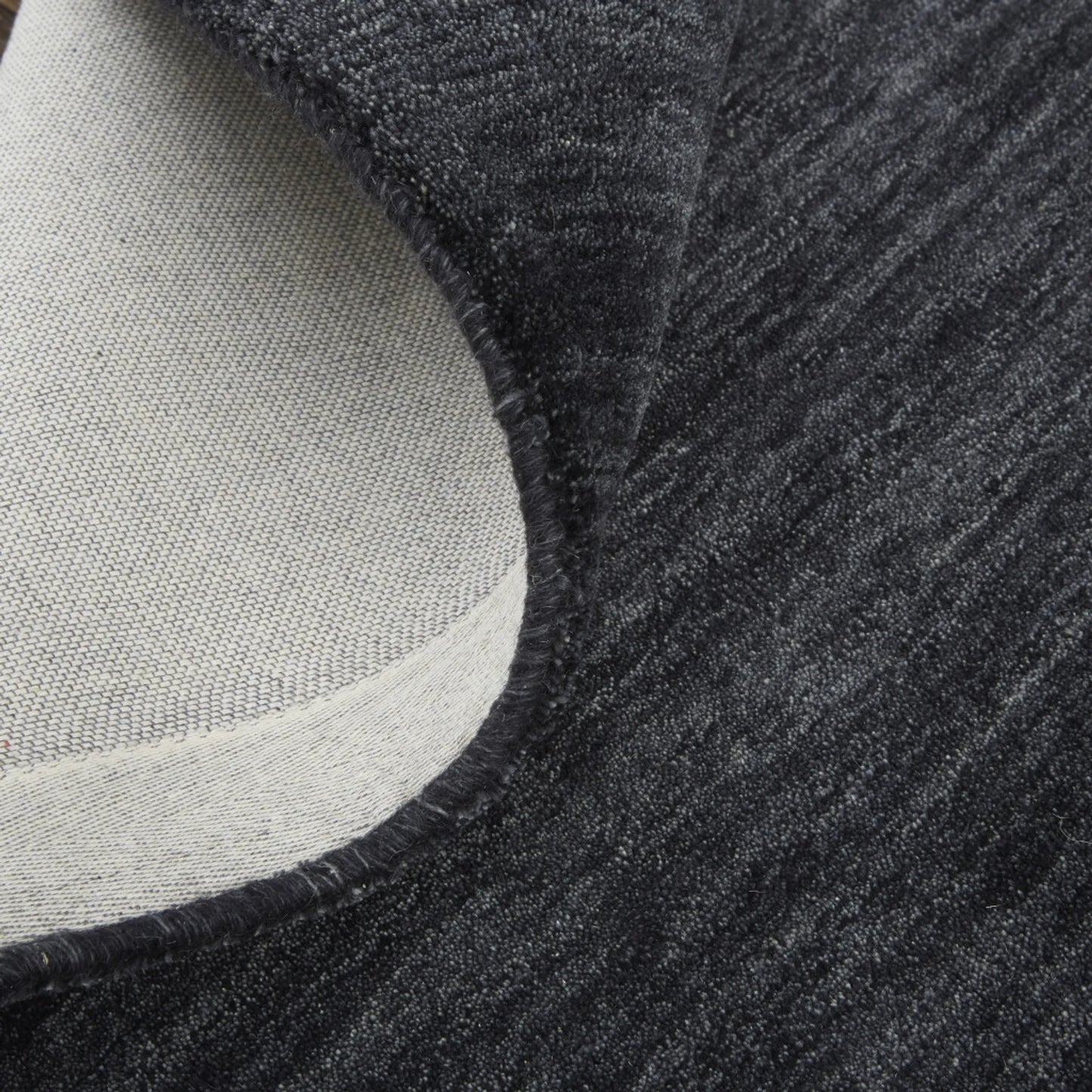Close-up of a textured black wool rug