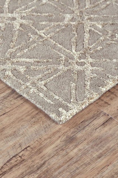 Close-up of a textured wool rug with geometric pattern on a wooden floor