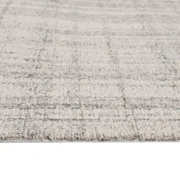 Close-up of a textured gray wool rug with a subtle pattern