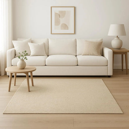 Modern living room with a beige sofa, jute  rug, and side table.