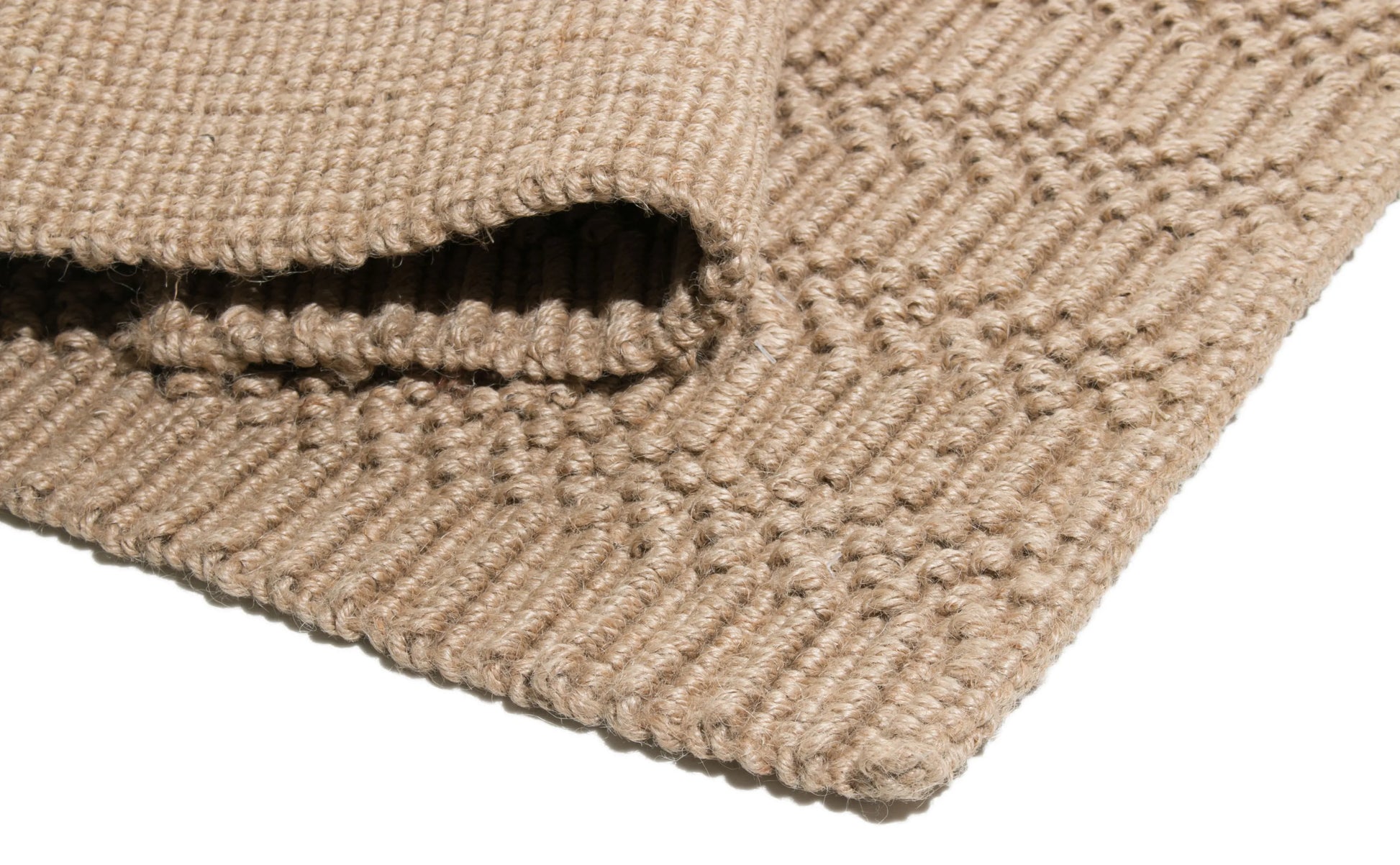 Close-up of a textured beige  jute rug on a white background