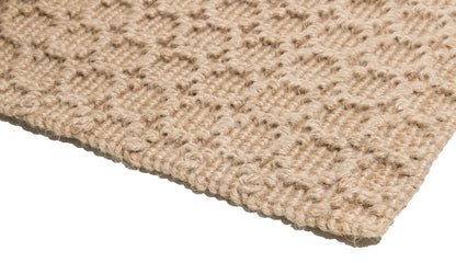 Close-up of a textured beige jute rug