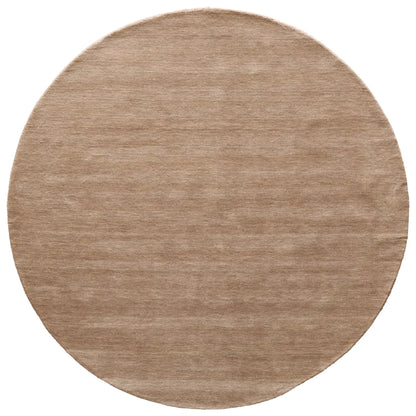 Round beige rug on a white background