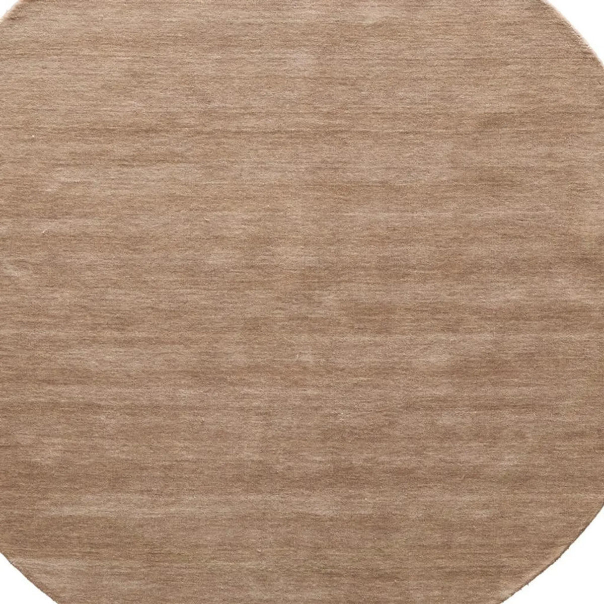A close-up of a round area rug with a soft, brushed texture in a warm taupe-brown color.