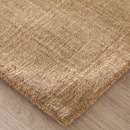 Close-up of a beige shaggy rug on a wooden floor