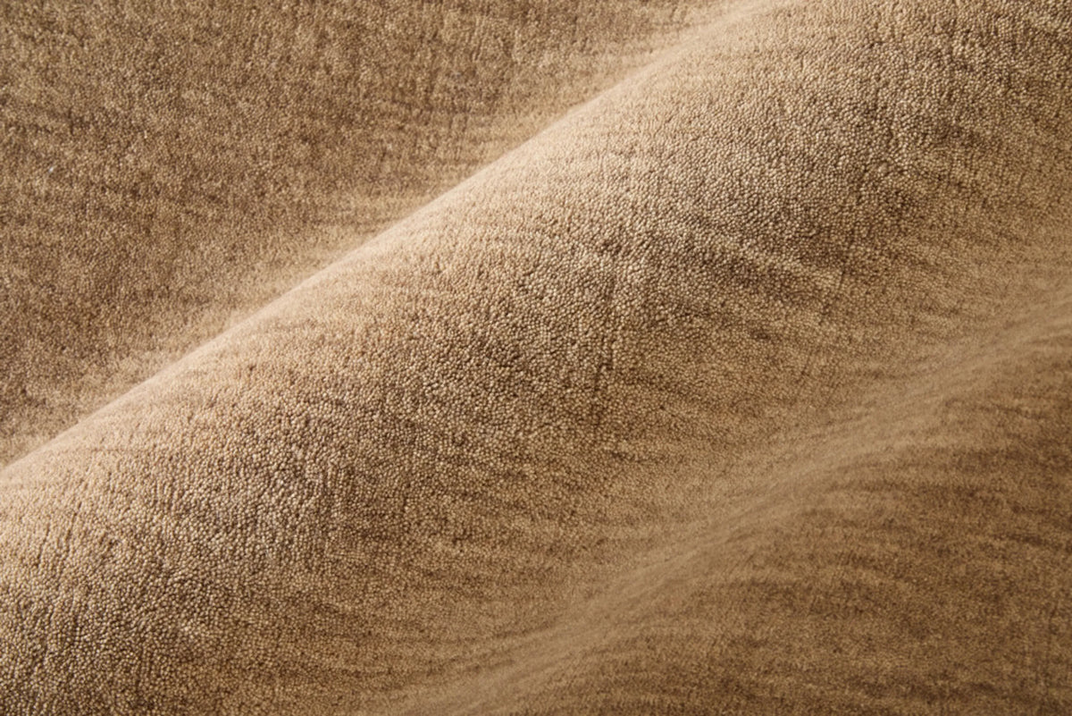  close-up of a warm tan wool rug 