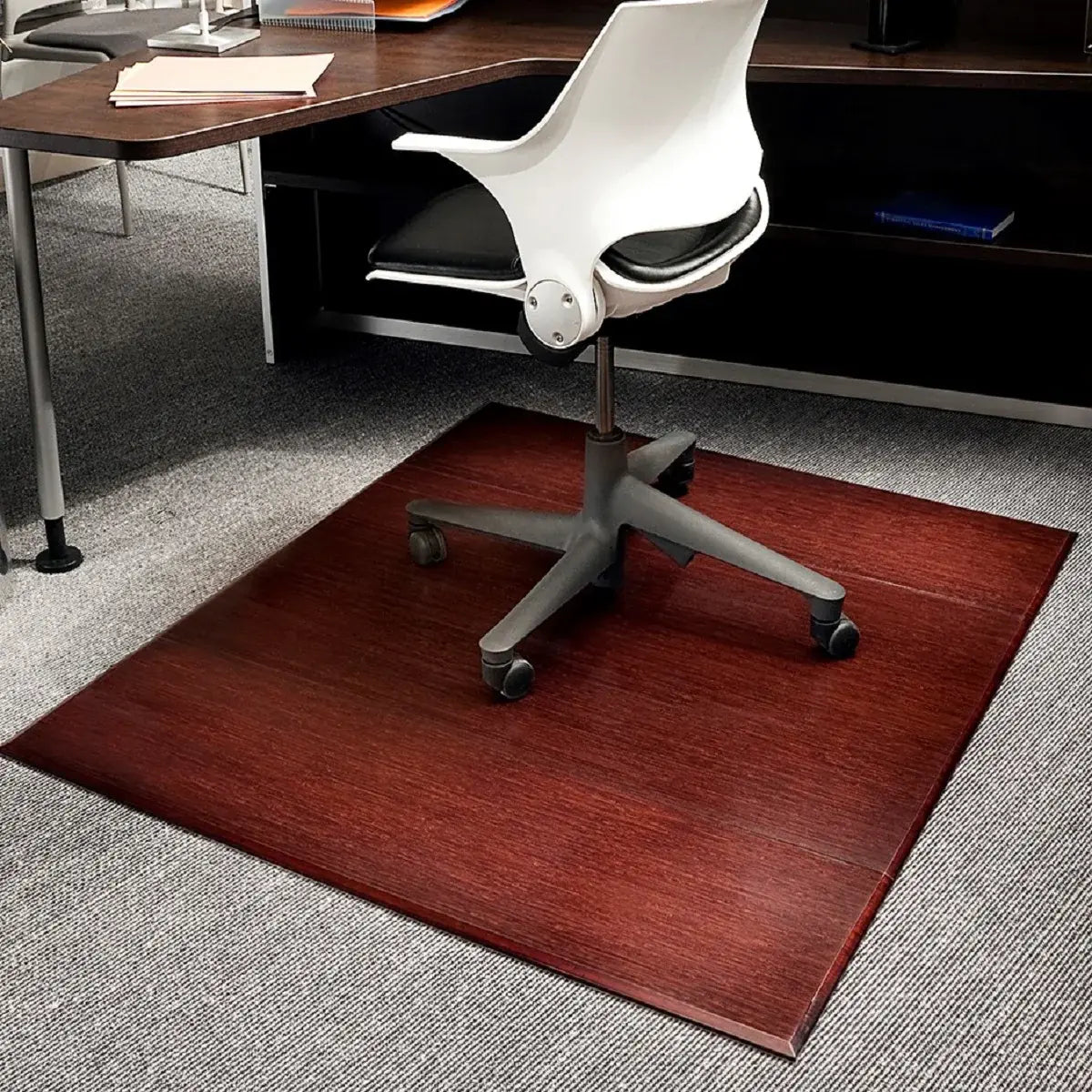 office with dark wood furniture, white and black chair