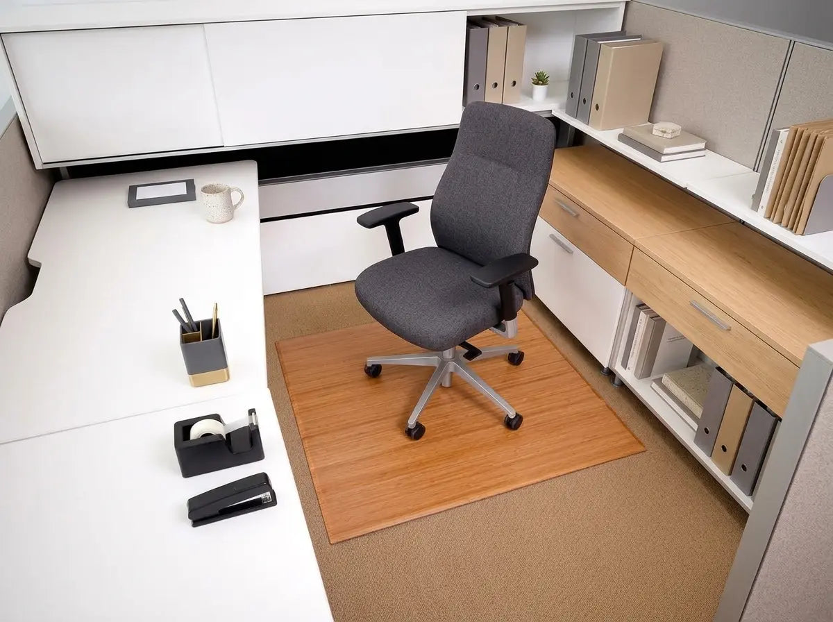 Natural bamboo foldable chair mat beneath a gray office chair on carpet.