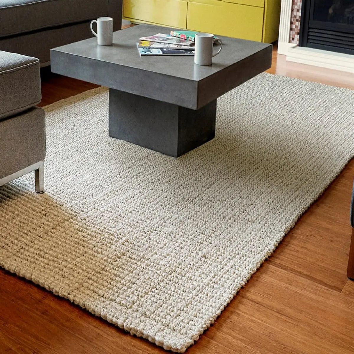 Modern living room with a gray coffee table on an ivory jute rug