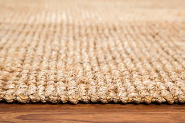 Close-up of a natural jute rug on a wooden floor