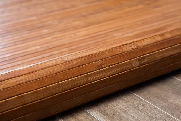 rolled under medium tone bamboo rug