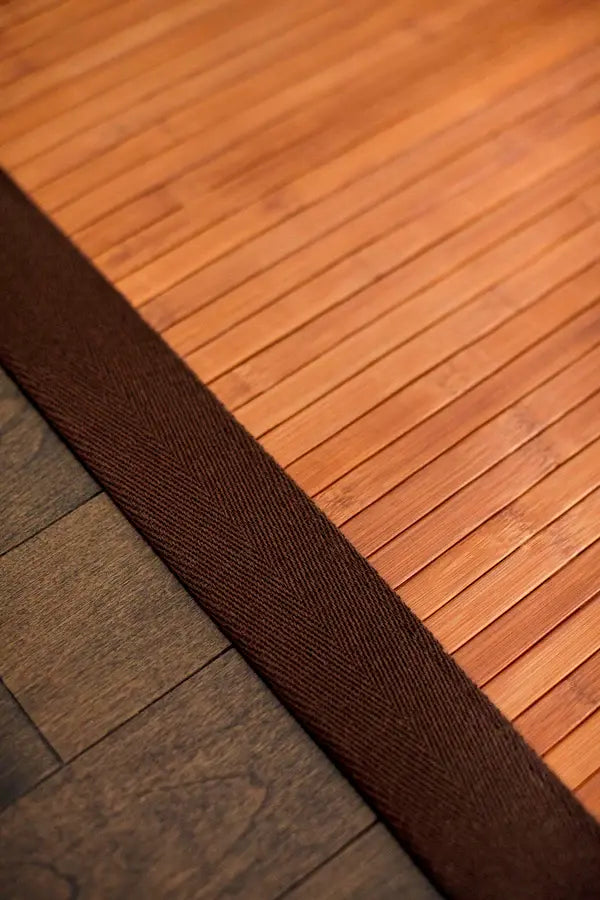 Close-up of a bamboo rug with a brown cotton border
