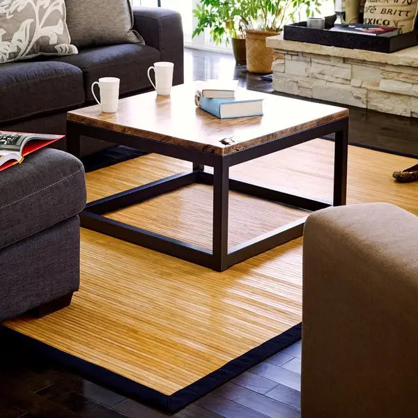 Living room with a wooden coffee table, gray sofa, decorative items and light bamboo rug