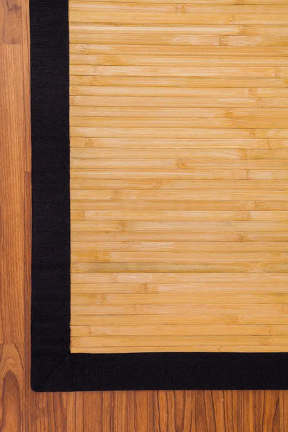 Bamboo rug with black border on wooden floor 