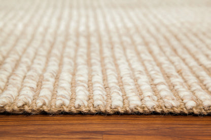 corner edge of ivory and tan woven rug