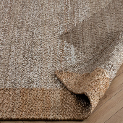 tan and taupe woven rug with corner turned back