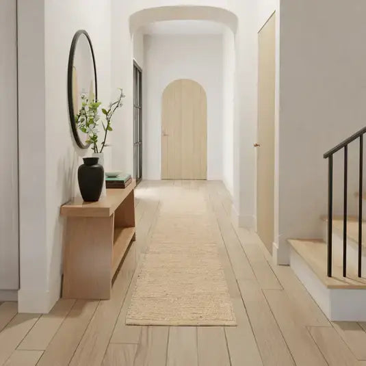 Modern hallway with wooden floor, mirror, and natural jute runner