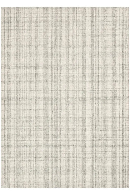 A square area rug with a distressed, textured plaid pattern in cream and light gray.