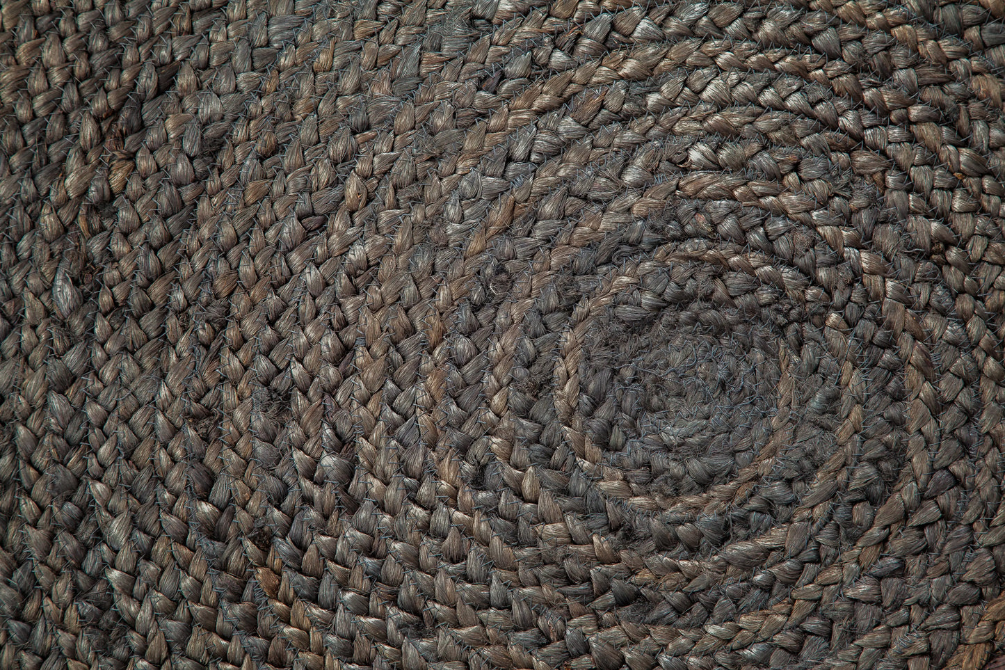close up of braided gray round jute rug