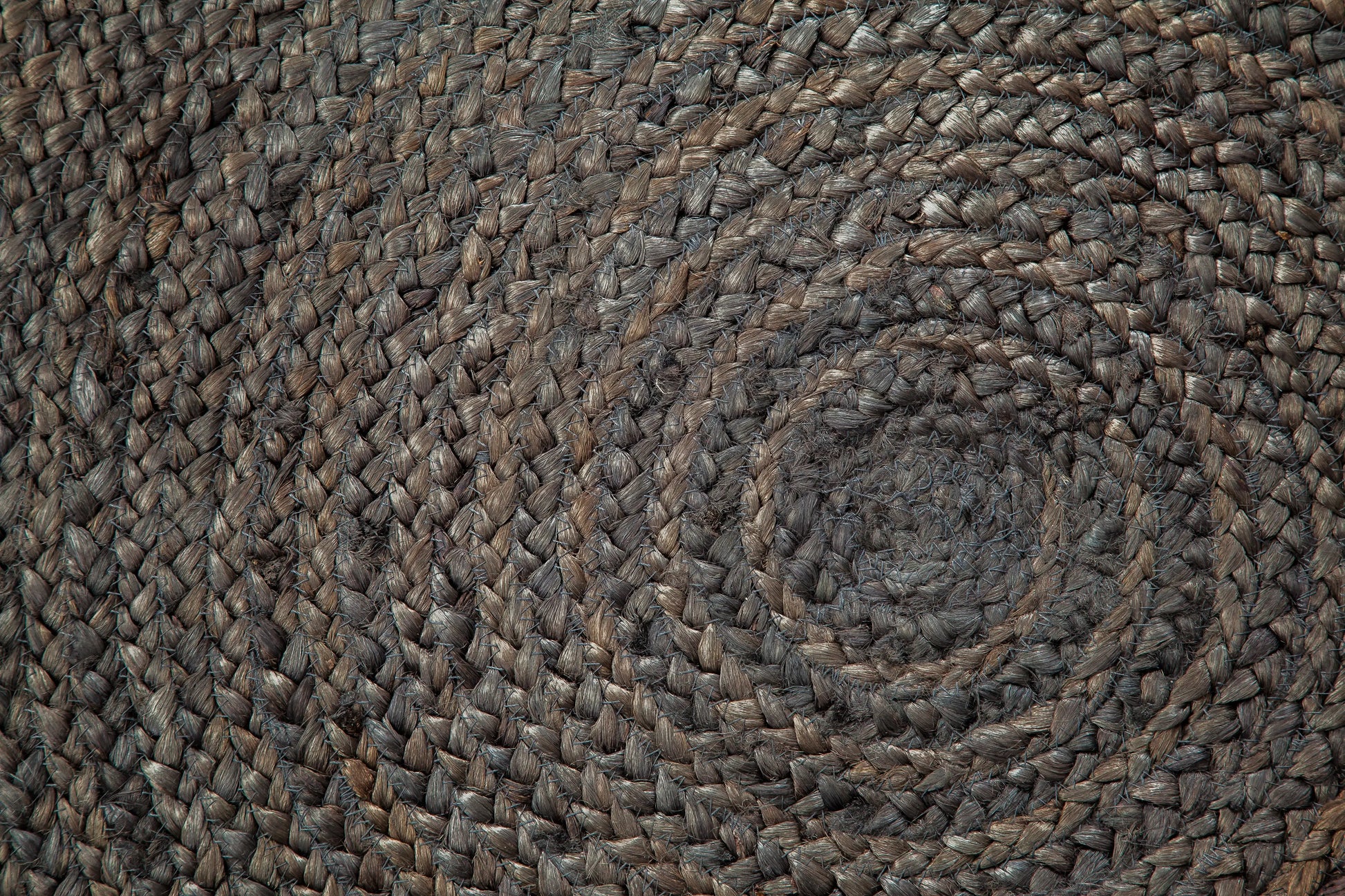 close up of braided gray round jute rug