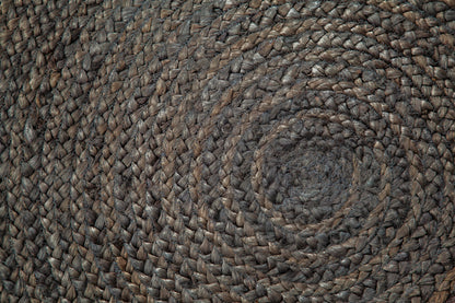 close up of braided gray round jute rug