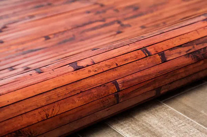 rolled up dark bamboo rug