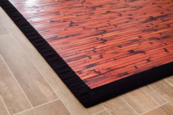 corner of dark bamboo rug with order on wood flloor