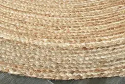 Close-up of a woven mat with a natural fiber texture on a dark surface