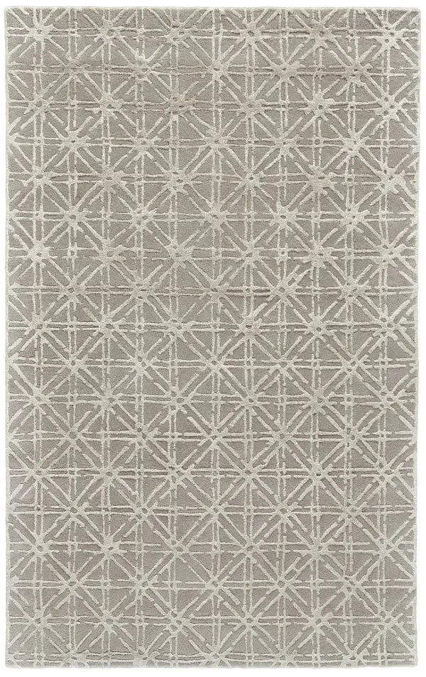 a tau[e and gray wool rug with a geometric pattern in ivory 