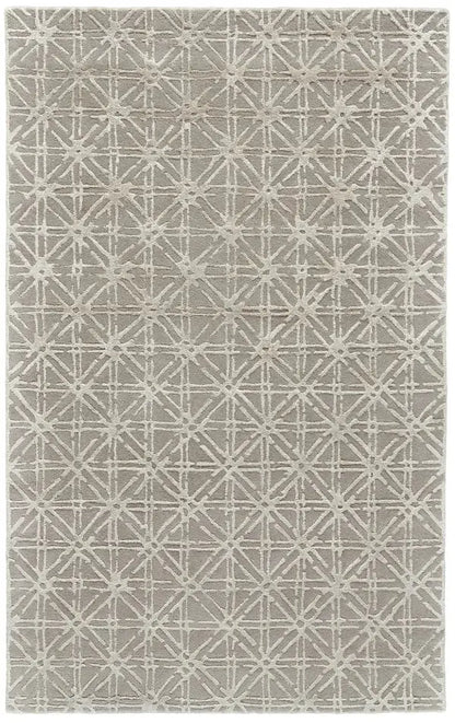 a tau[e and gray wool rug with a geometric pattern in ivory 
