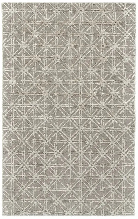 a tau[e and gray wool rug with a geometric pattern in ivory 