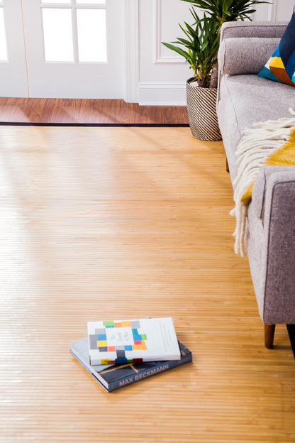  Desert Sand Moso Bamboo Rug in front of couch