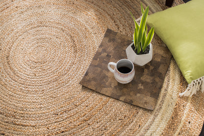 overhead view of round jute rug with decorative accessories