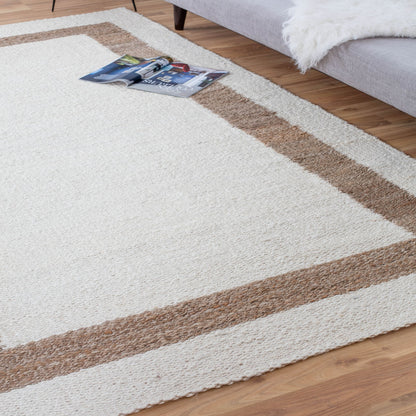 Whippoorwill Handloom Woven Jute Area Rug close up with magazine