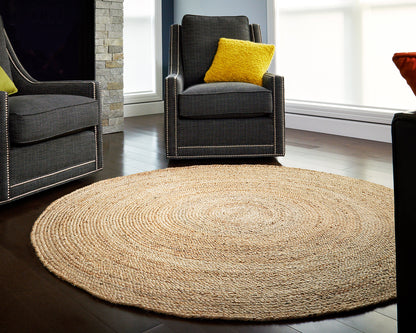 6' x 6' Round Kerala Natural Jute Rug in front of gray chairs